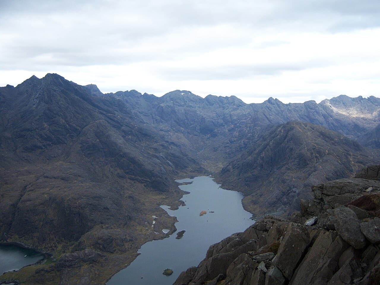 Loch Coruisk stretches along a bare rock glen completely ringed by the jagged peaks of the Black Cuillin, seen from the summit of Sgurr na Stri.